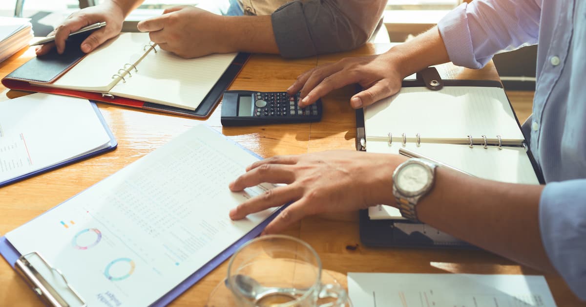 A SaaS Year Wrapped_ How a Boise-Based Fractional CFO Turned Financial Delivery into Strategic Advantage Hands working on financial documents together
