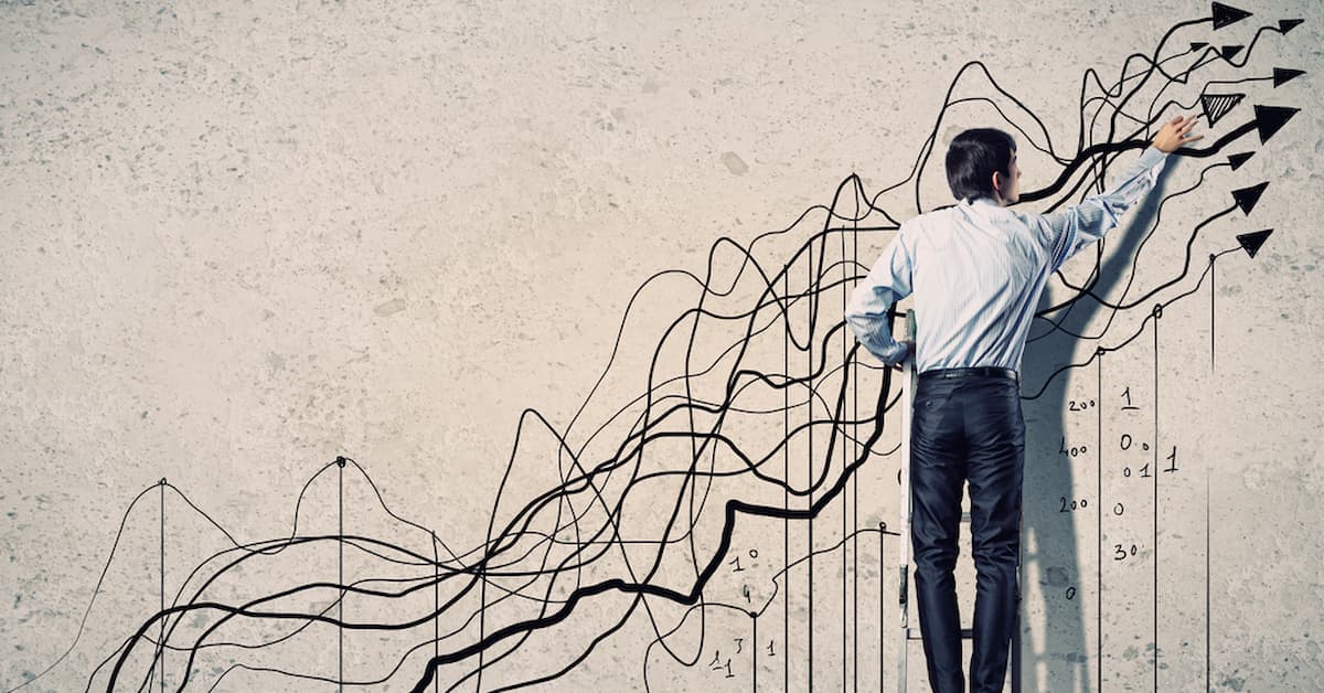 Businessman illustrating growth on wall