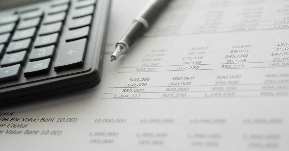 Calculator and financial documents on table