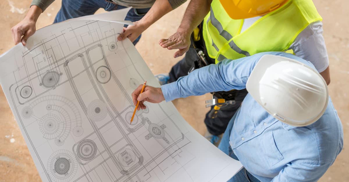 When $1M in Unallocated Costs Hid the Truth and What Changed After Fixing Job Costing Construction workers reviewing blueprints together.