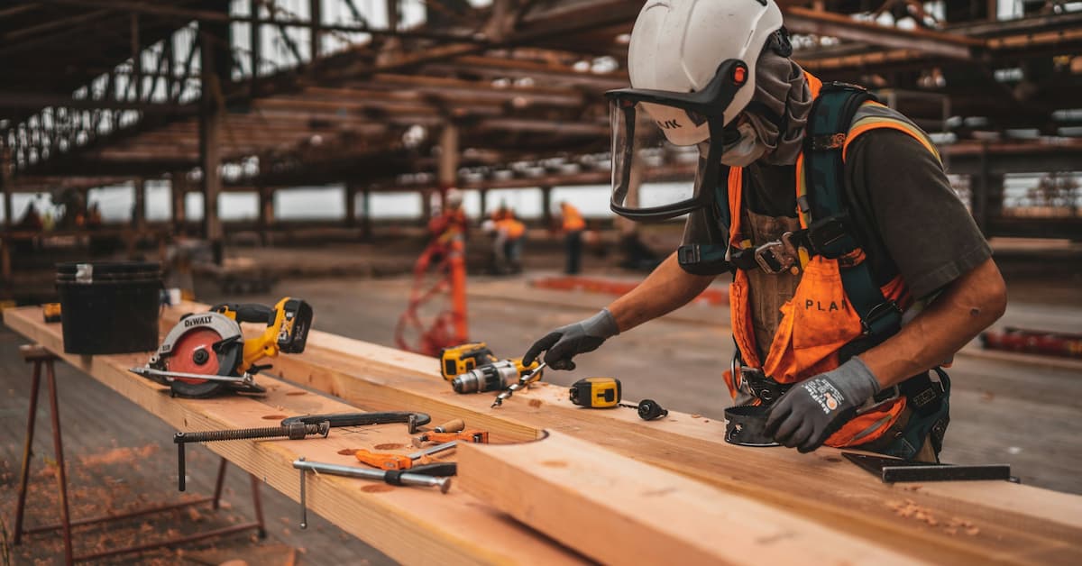Construction worker using power tools