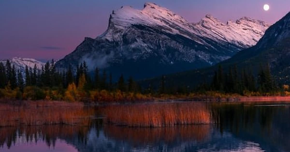 shooting star-1 Serene lake reflecting snowy mountains.